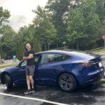Mark Cool leaning on a Tesla