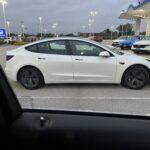 Looking at the Tesla through the window of the new Jeep. 