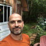 Mark Cool in front of his tiny house.